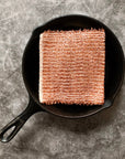 A copper cleaning cloth in a cast iron pan